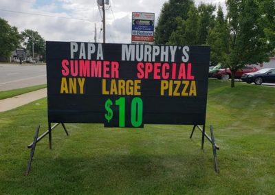 Light Bright Signs portable black signs on the road in Jension promoting a special for Papa Murphy's Pizza with a colorfully letters