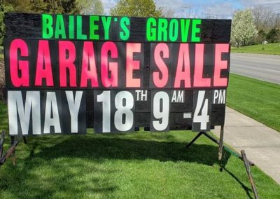 Bailey's Grove in Kentwood, Michigan promoting garage sales with a portable black sign