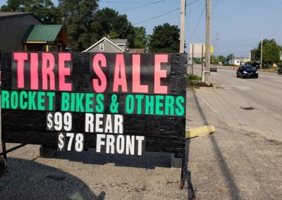 Grand Rapids area autmotive retailer uses a Light Bright custom portable sign to promote a tire- Michigan's leader in black signs!