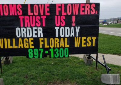 Village Floral in Lowell using a black sign promoting Mother's Day